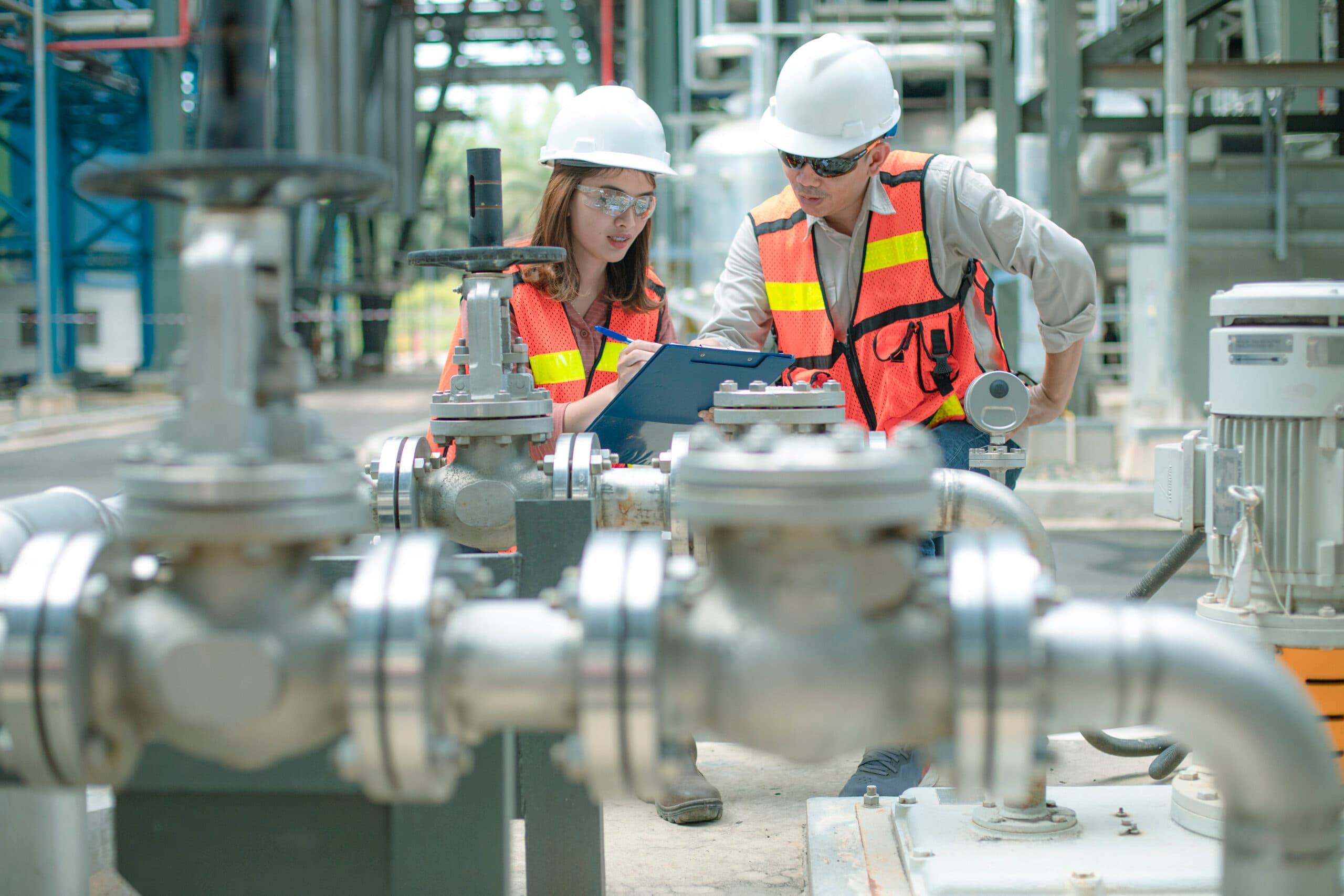 Engineers at a pyrolysis plant site reviewing construction and deployment plans
