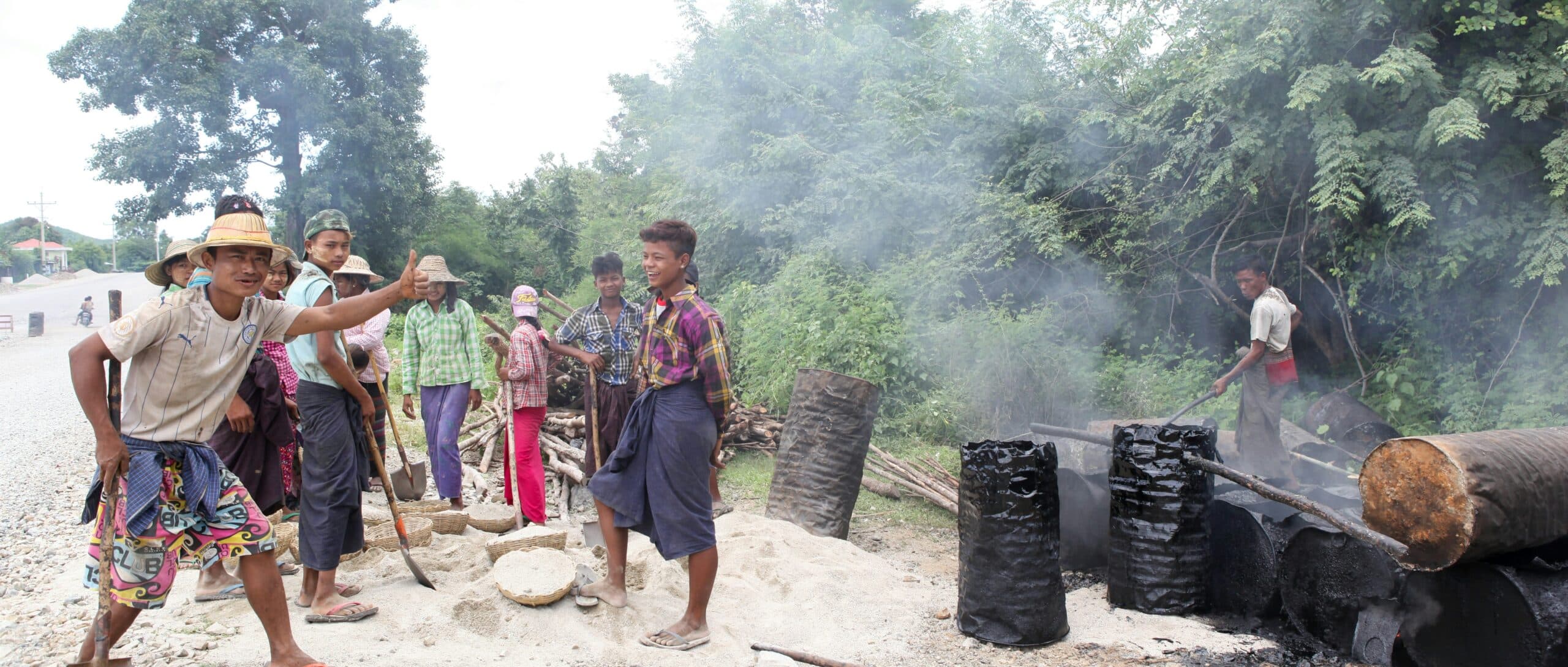 Biomass being converted to biochar through traditional charcoal production